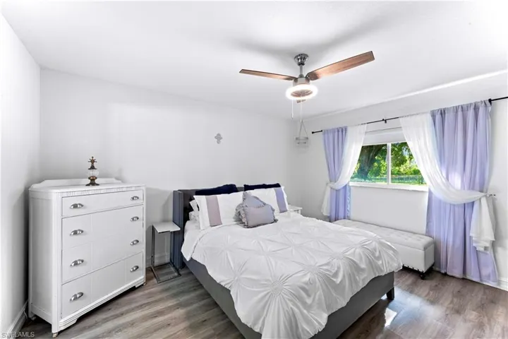 Bedroom with wood finished floors and a ceiling fan