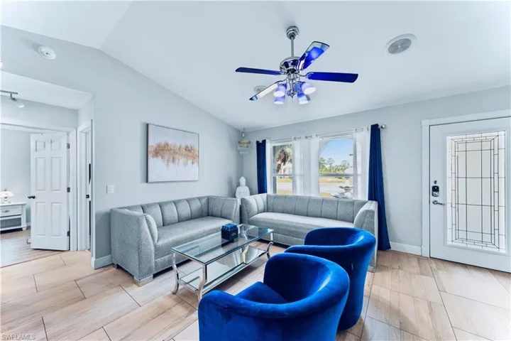 Living room featuring lofted ceiling and ceiling fan