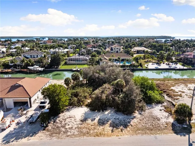 Aerial perspective of suburban area featuring a large body of water