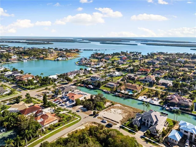 Aerial view of property's location featuring nearby suburban area and a nearby body of water