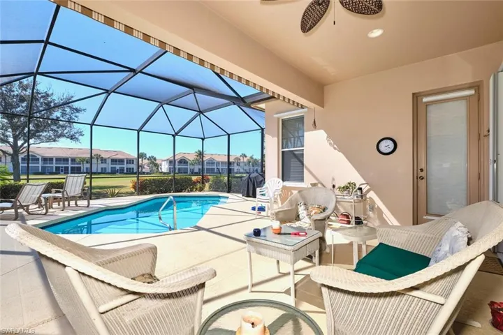 Outdoor pool featuring a patio area, a sunroom, a residential view, and a lanai