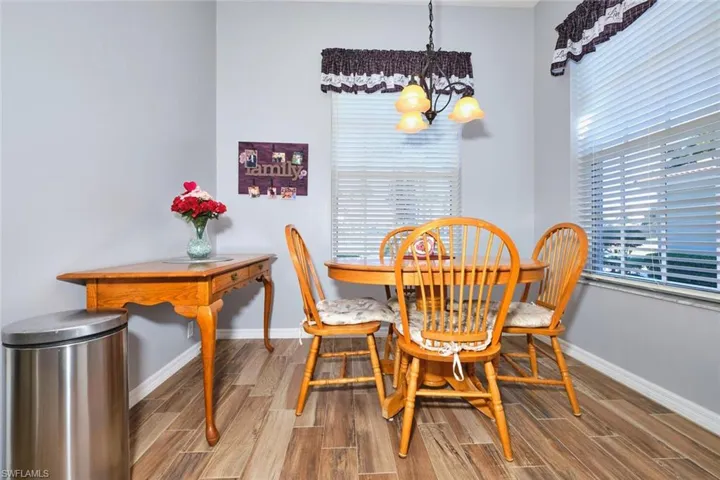 Dining area with suspended lighting and wood tiled floors