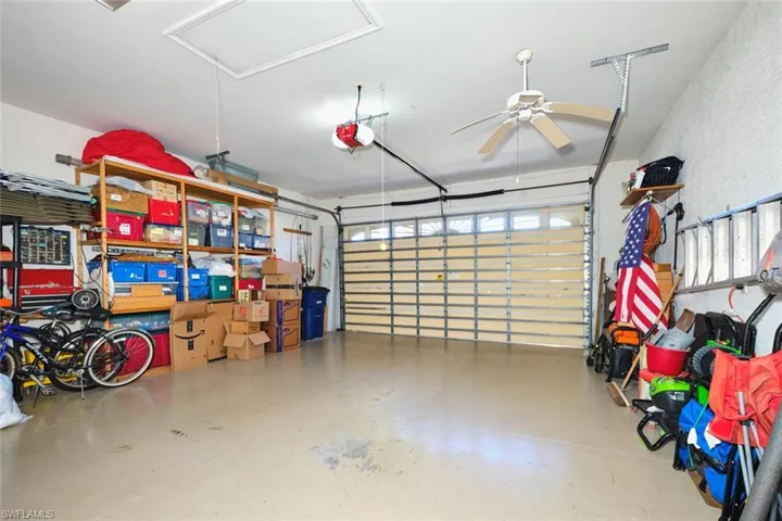Garage with a garage door opener and ceiling fan