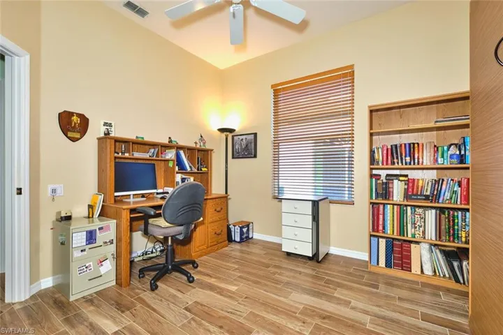 Office space featuring wood tiled floors and a ceiling fan