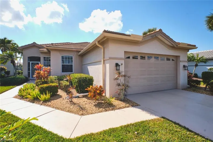 Mediterranean / spanish home with concrete driveway, stucco siding, a tiled roof, and an attached garage