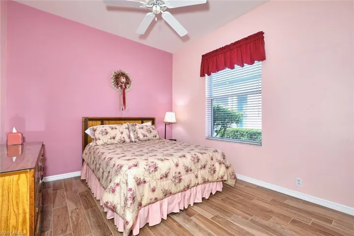 Bedroom featuring wood tiled floors and ceiling fan