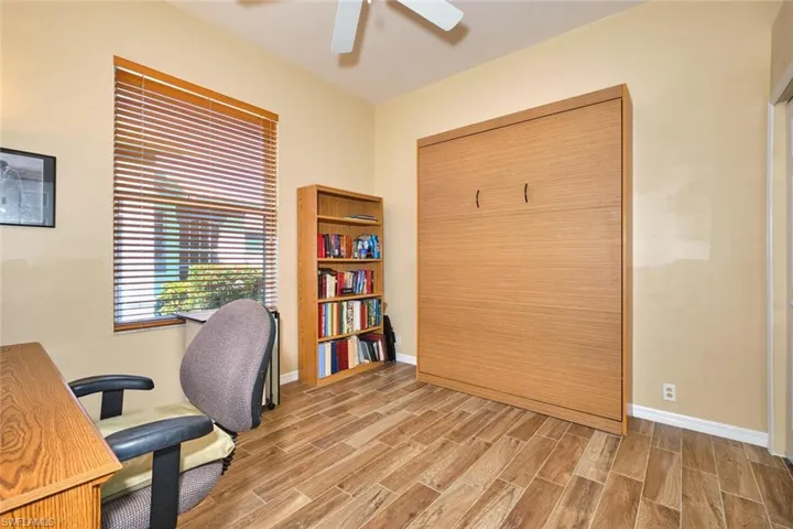 Office with wood tiled floors and ceiling fan
