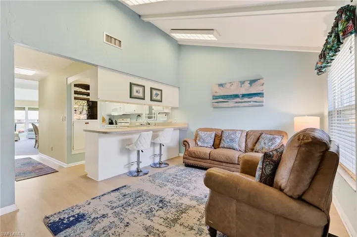 Living room has site lines into the kitchen and you can see the kitchen has a great breakfast bar for casual dining