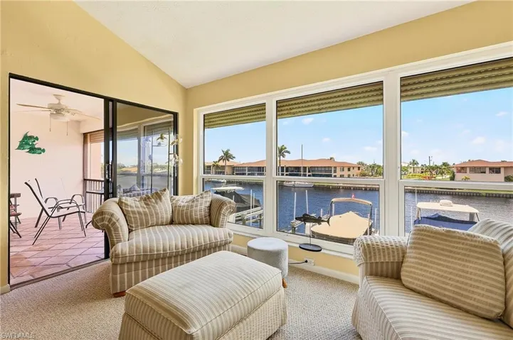 The best part of the large family room are these floor to ceiling windows that look right out to the water. Also, you have sliders that lead out to yet another area, a screened in lanai