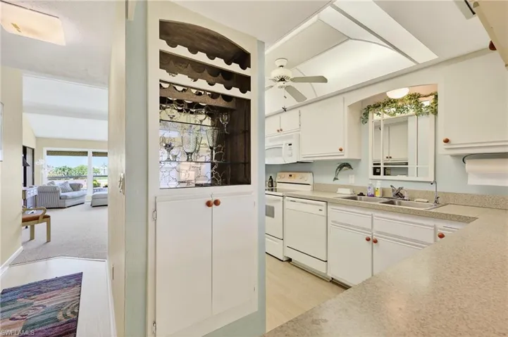 The kitchen is light & bright, feautring white cabinets, all the appliance + a wine cooler!