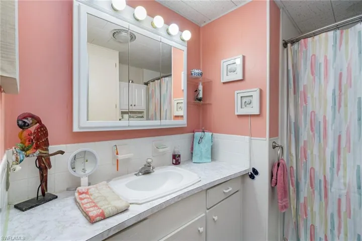 Bathroom with vanity and curtained shower