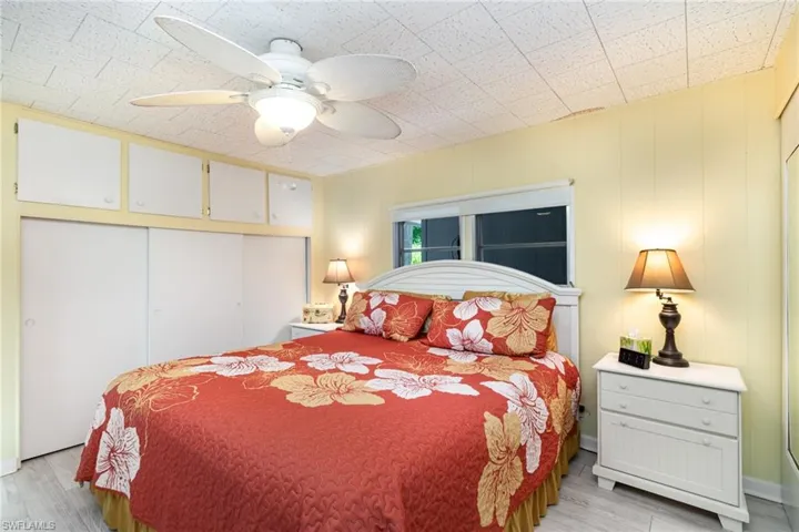 Bedroom with a closet, light wood finished floors, and a ceiling fan