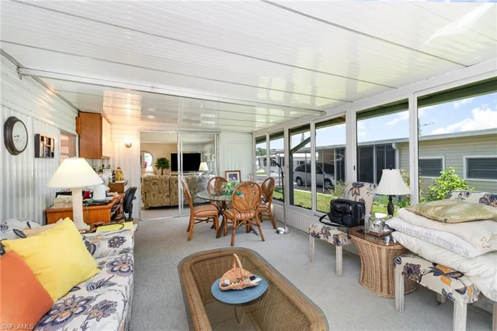 Sunroom with carpet floors and an outdoor living space