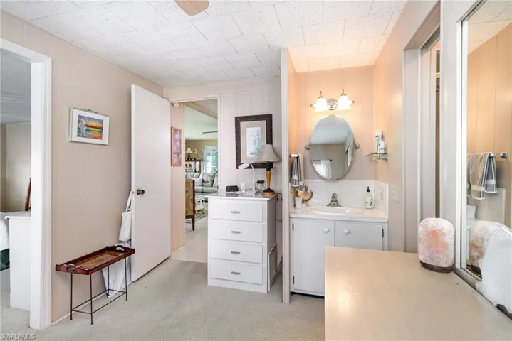 Full bath with vanity and wooden walls