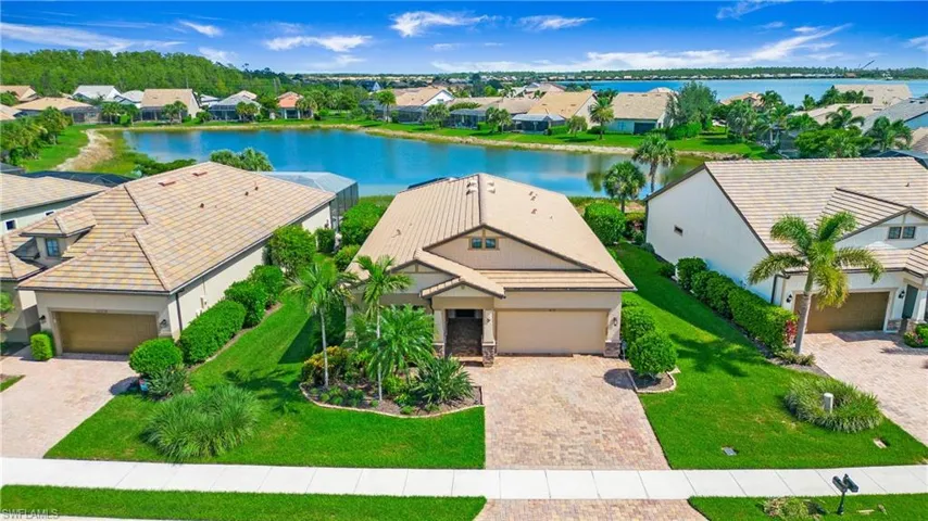 Aerial view of residential area featuring a nearby body of water