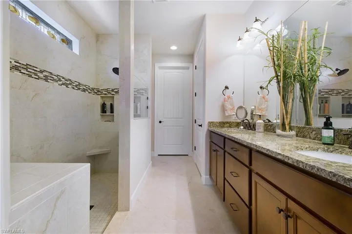 Full bath featuring double vanity, a walk in shower, and recessed lighting