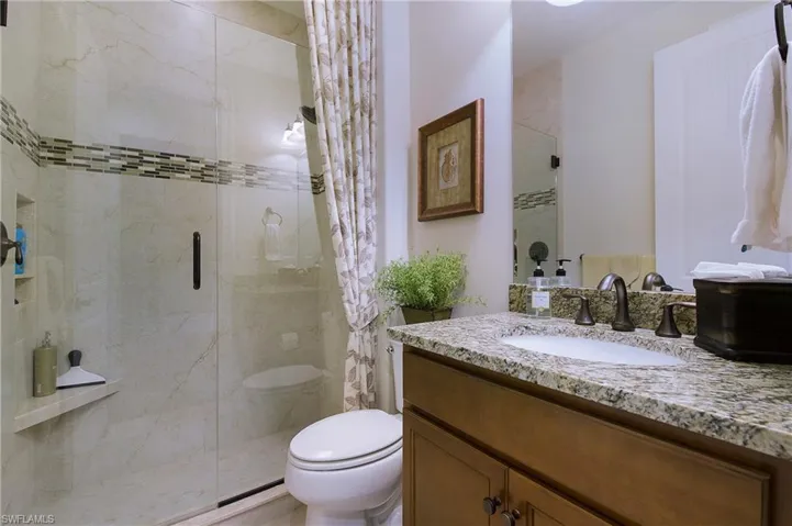 Bathroom featuring a stall shower and vanity