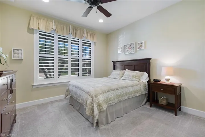 Bedroom featuring light carpet, recessed lighting, and ceiling fan