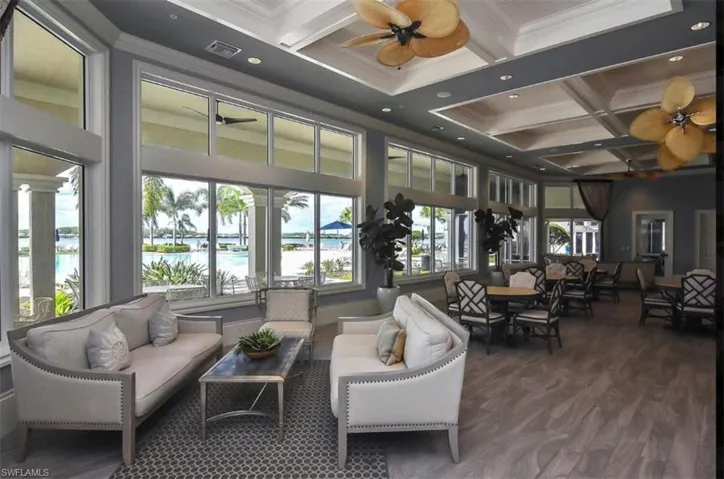 Building lobby with coffered ceiling, crown molding, beamed ceiling, a water view, and recessed lighting