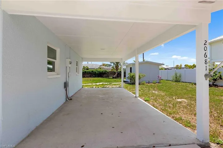 View of patio with an outdoor structure and an attached carport