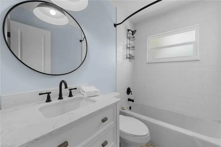 Full bath featuring vanity, toilet, and bathtub / shower combination