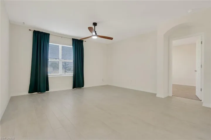 Empty room featuring a ceiling fan and light wood finished floors