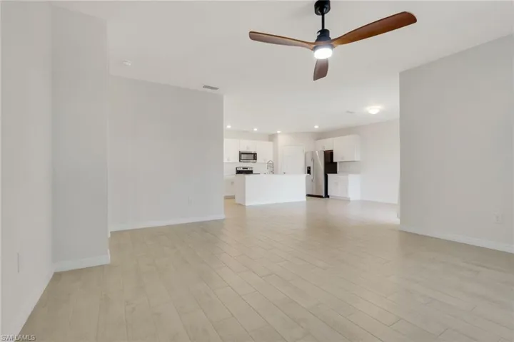 Unfurnished living room with ceiling fan, light wood finished floors, and recessed lighting