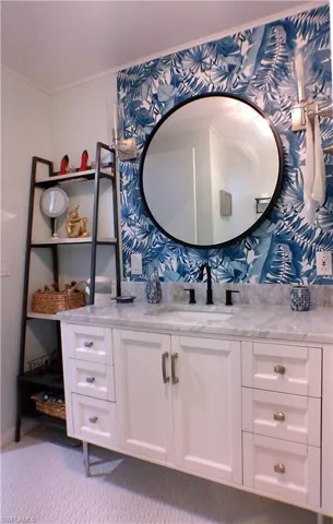 Bathroom featuring vanity and light carpet