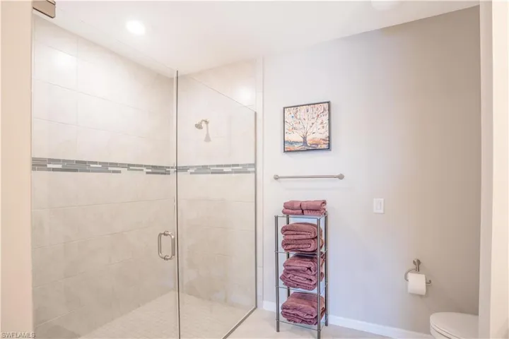 Bathroom featuring walk in shower and toilet