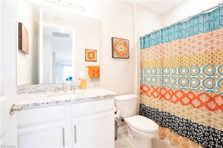 Bathroom with tile patterned flooring, toilet, and vanity