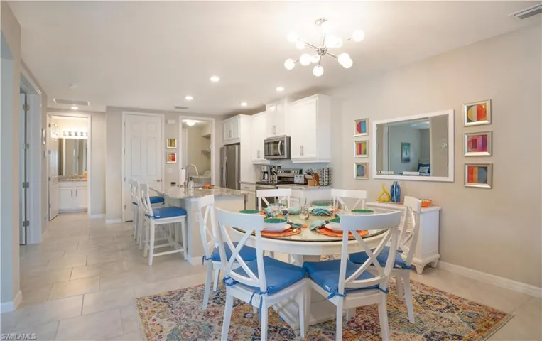 Dining room with sink, an inviting chandelier, and light tile patterned floors