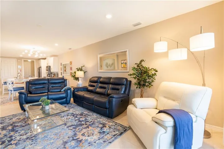 Living room featuring light tile patterned floors and an inviting chandelier