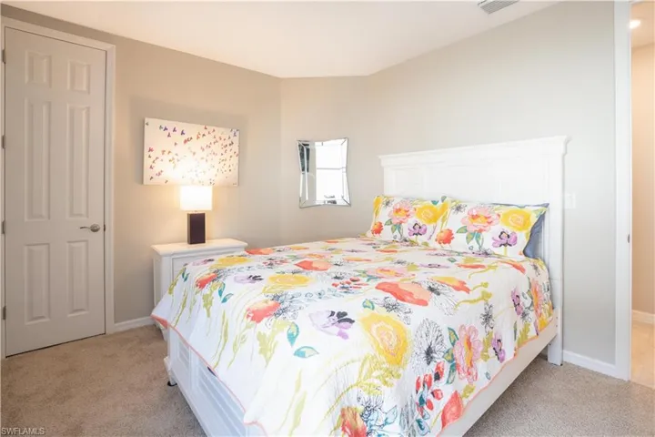 Bedroom with light carpet