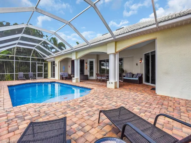 View of swimming pool featuring a lanai, an outdoor living space, and a patio area