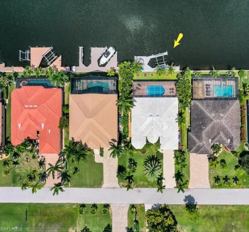 Birds eye view of property with a water view