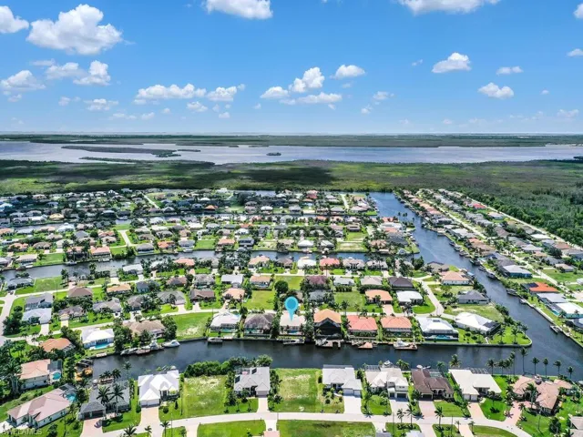 Birds eye view of property with a water view