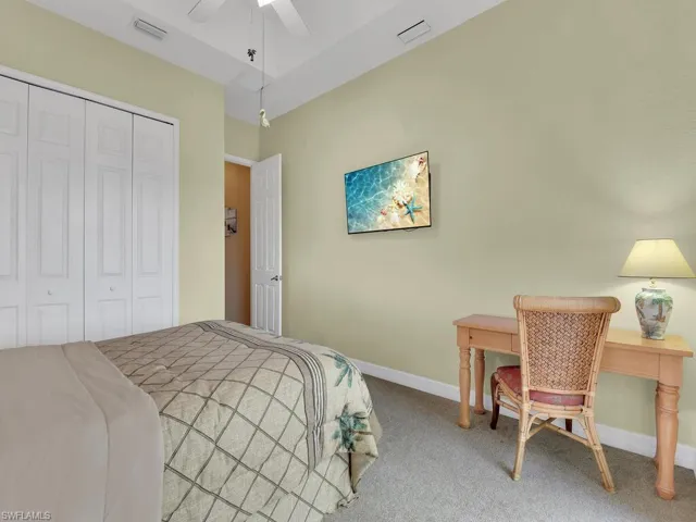 Bedroom featuring a closet, carpet, and ceiling fan