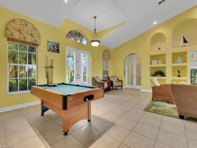 Game room with built in shelves, french doors, billiards, and light tile patterned flooring
