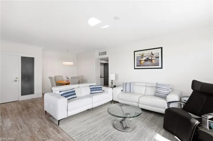 Living room featuring crown molding and wood-type flooring