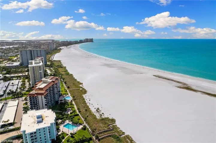 Drone / aerial view with a beach view and a water view