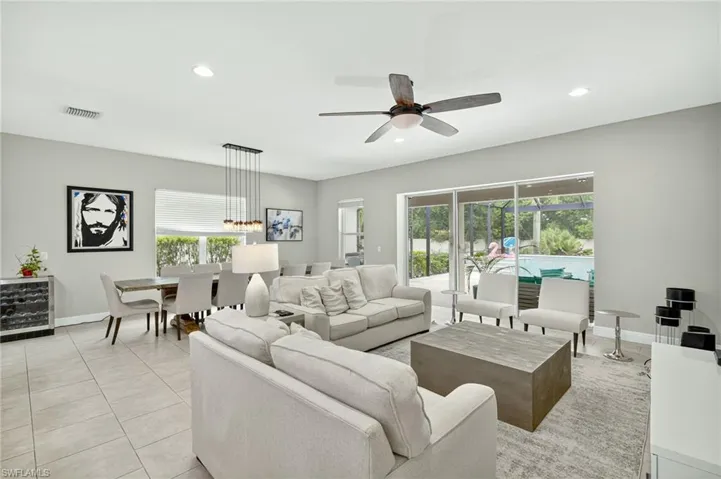 Living area featuring recessed lighting, light tile patterned floors, and ceiling fan