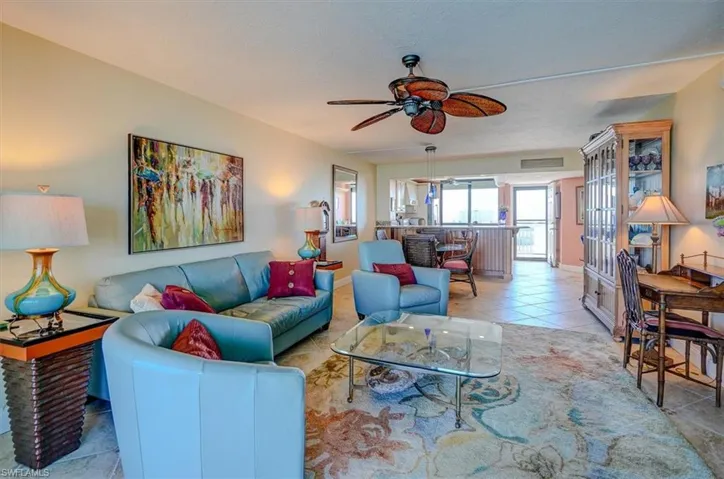 VIEW FROM LIVING AREA TOWARDS KITCHEN, UNIT ENTRANCE.  GUEST BEDROOM AND LAUNDRY ROOM IS AT UPPER RIGHT.