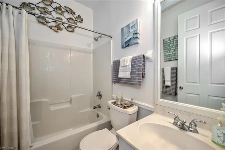 Full bathroom with vanity, toilet, and shower / tub combo