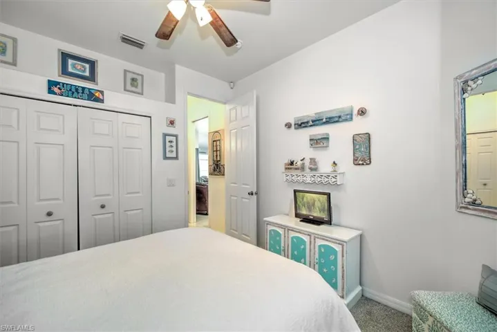 Bedroom featuring carpet flooring, a closet, and ceiling fan