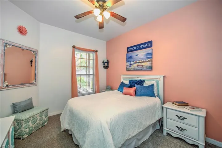 Carpeted bedroom with ceiling fan