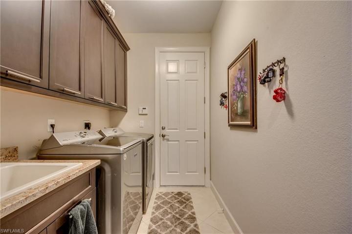 Laundry Room with Washer/Dryer, Laundry Tub, Cabinets.  Door leads to garage, which is 3 car oversized and Mini Split A/C system that is 2019