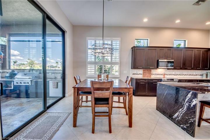 view of dining area off kitchen, with waterfall granite to the right, new plantation shutters