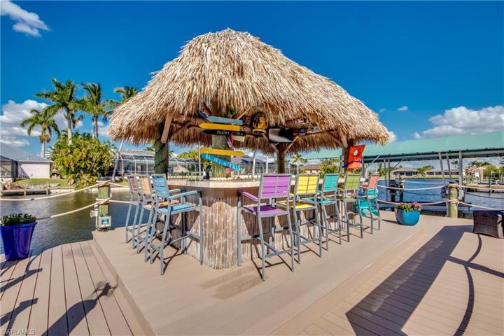 The Ultimate Tiki Hut with 8 Custom Bar Stools.  Decorations and TV comes with Dock.  The Dock is made of the Trex Lifetime Decking