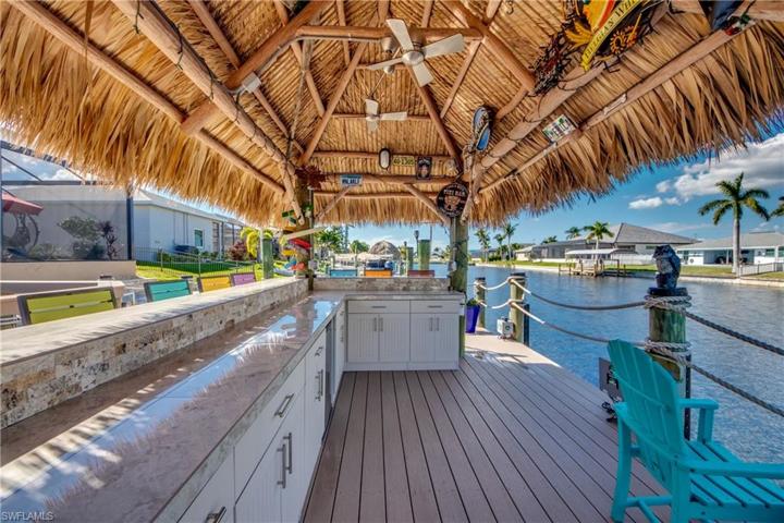 Your Custom Tiki HUT features custom storage, Refrigerator, ceiling fan, New Refrigerator, Custom Countertop and Backsplash,  the deep water Canal measured at 25 feet deep !!