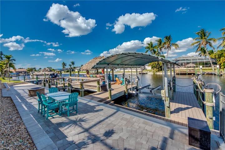 Possibly the Finest Party Dock in all of Cape Coral !!  Gas Firepit!  6 Underwater Fish Lights, in the middle is your own MINI LAGOON!  Captains Walk around Boat Slip with your Boat Canopy and 10,000 lift